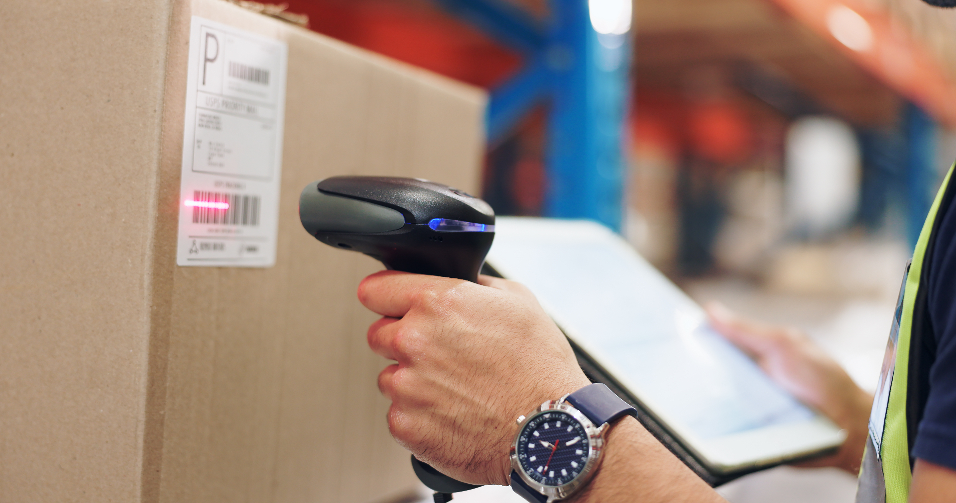 Warehouse worker scanning a barcode on a box with a handheld scanner